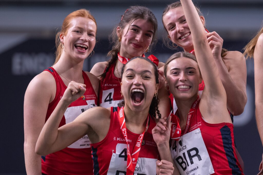 Group of women celebrating sporting win with medals