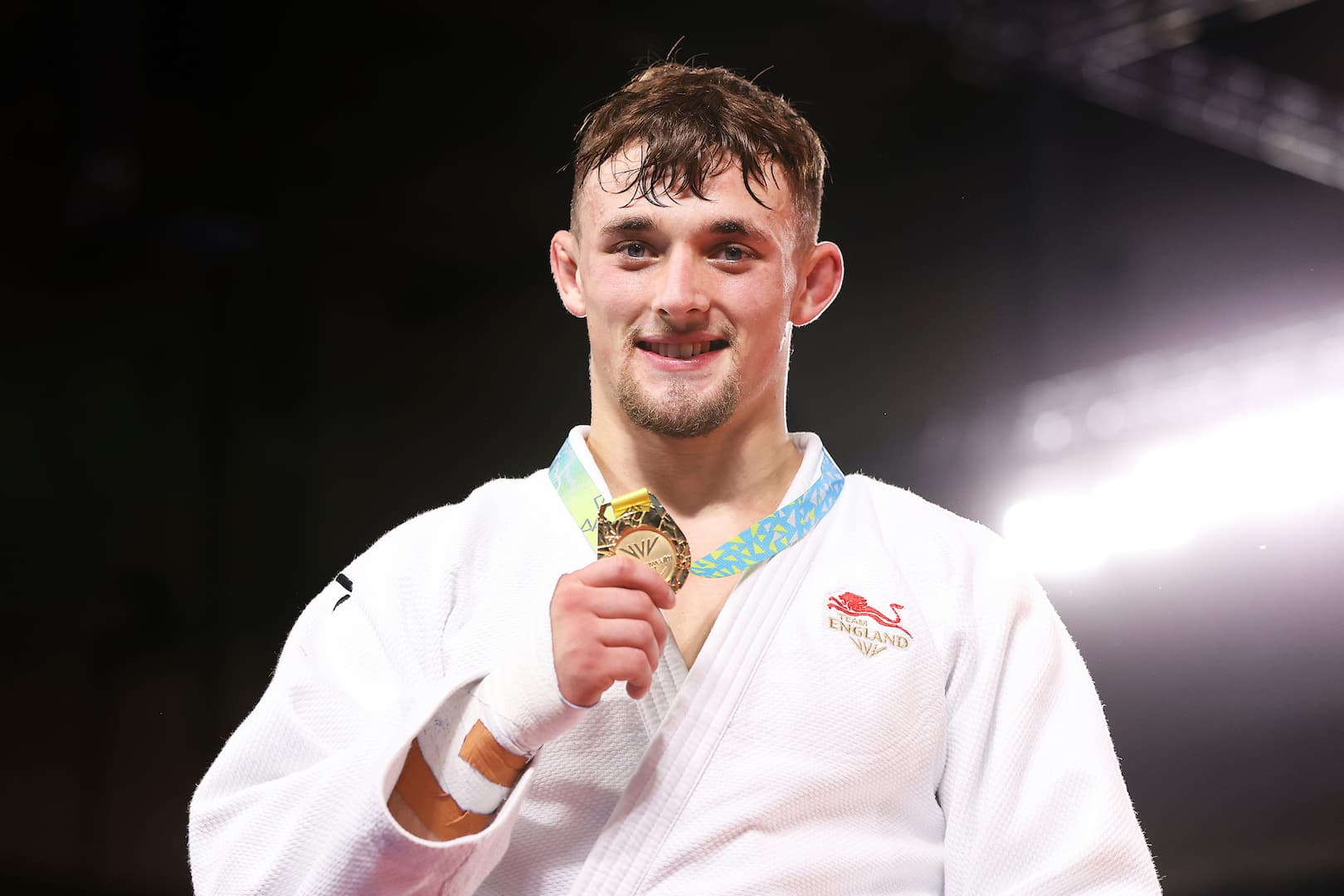 Lachlan Moorhead smiling at the camera with his gold medal