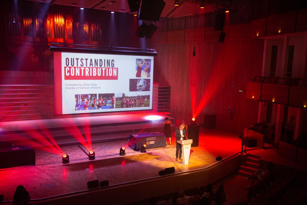 Sports Awards with Outstanding Contribution on the screen behind.