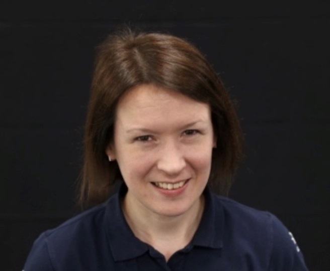 Jo Eley smiling at the camera wearing a blue top