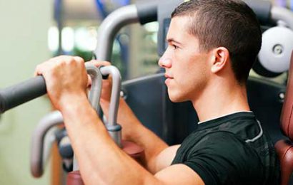 Man working out in gym on machine