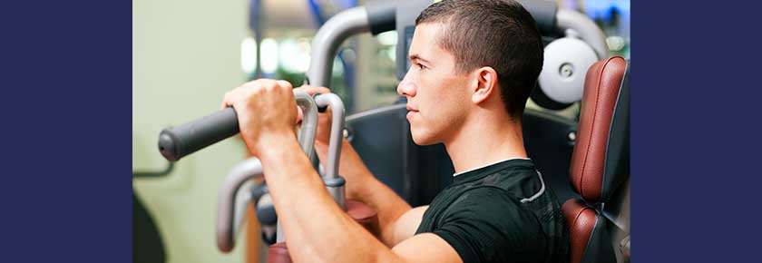 Man working out in gym on machine