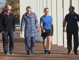Four members walking along the promenade outside Sport & Fitness pool