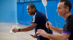 Two over 65 males playing badminton in the sports hall