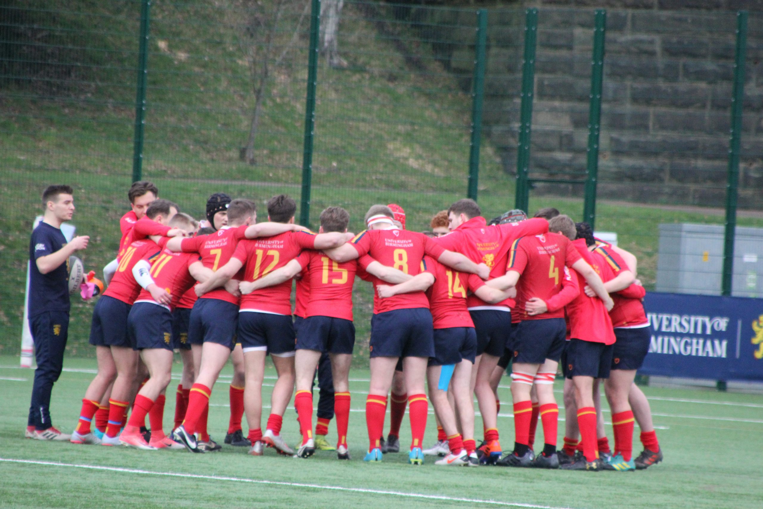 Group of Rugby players huddled together