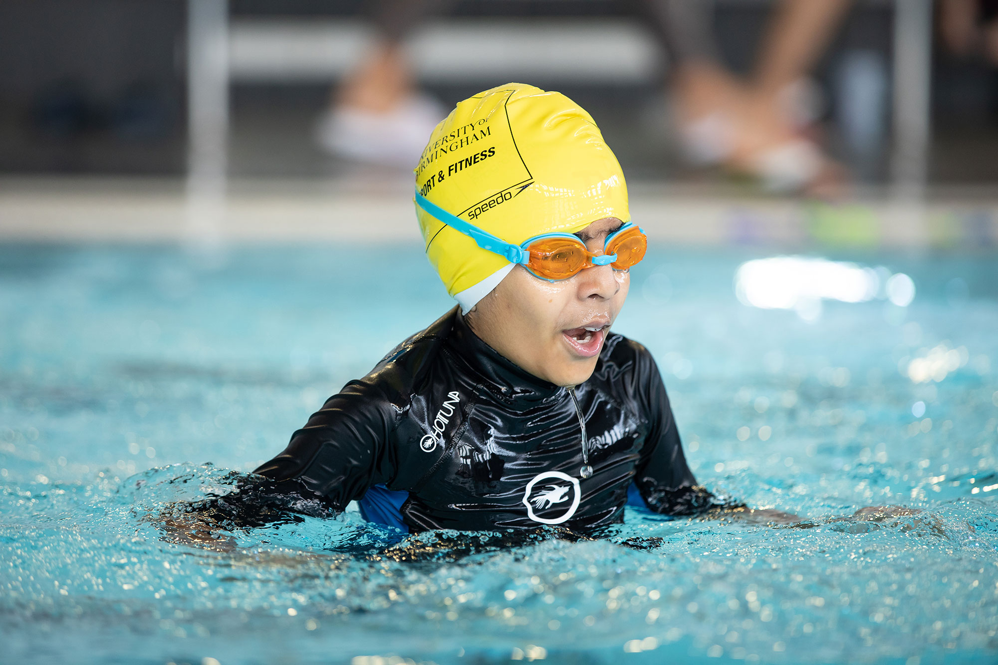 Junior in a swimming hat in the pool