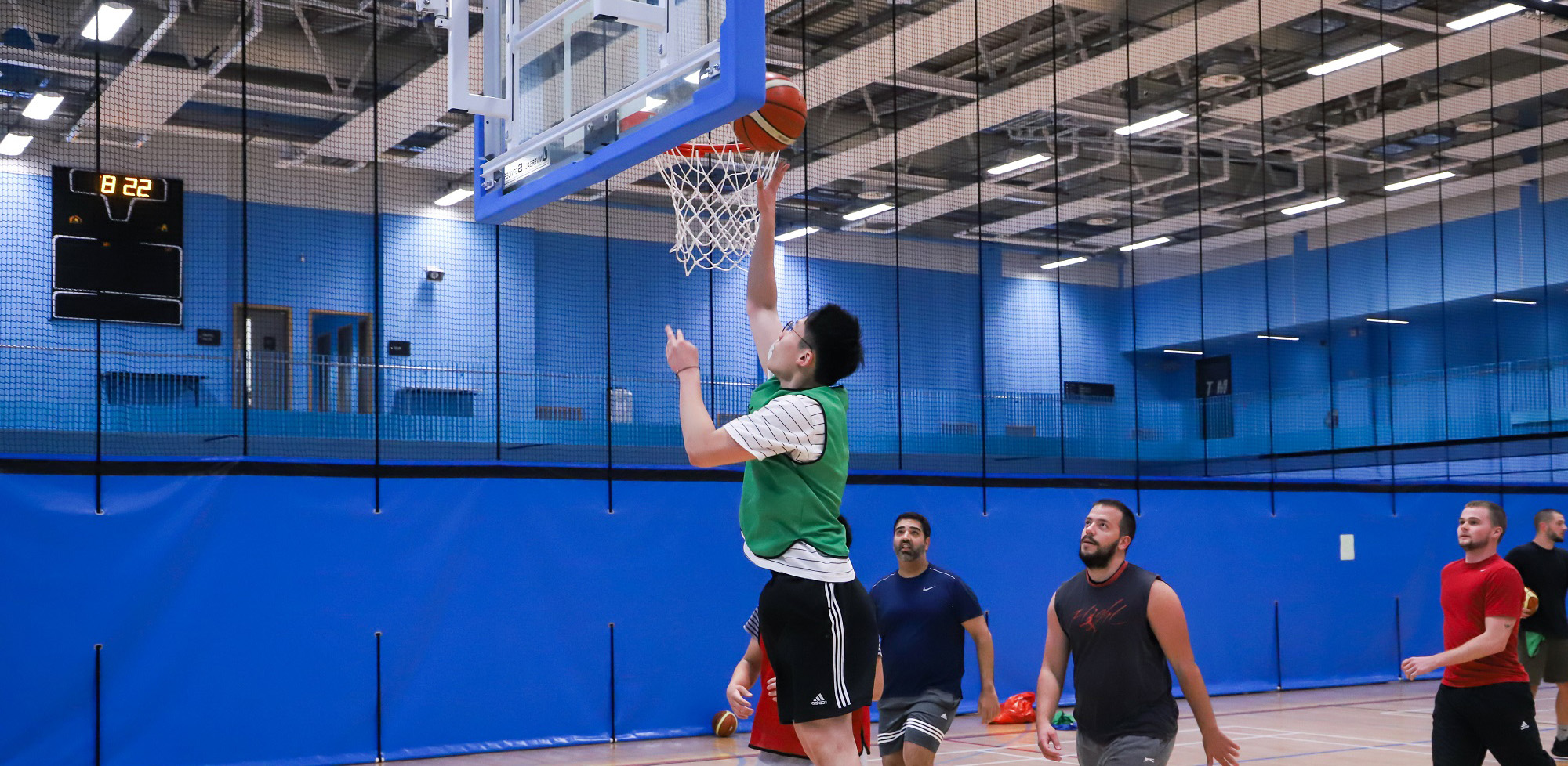 Basketball player jumping next to the hoop