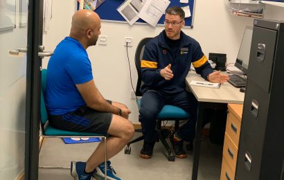 Peter and Hasan discussing training in the office
