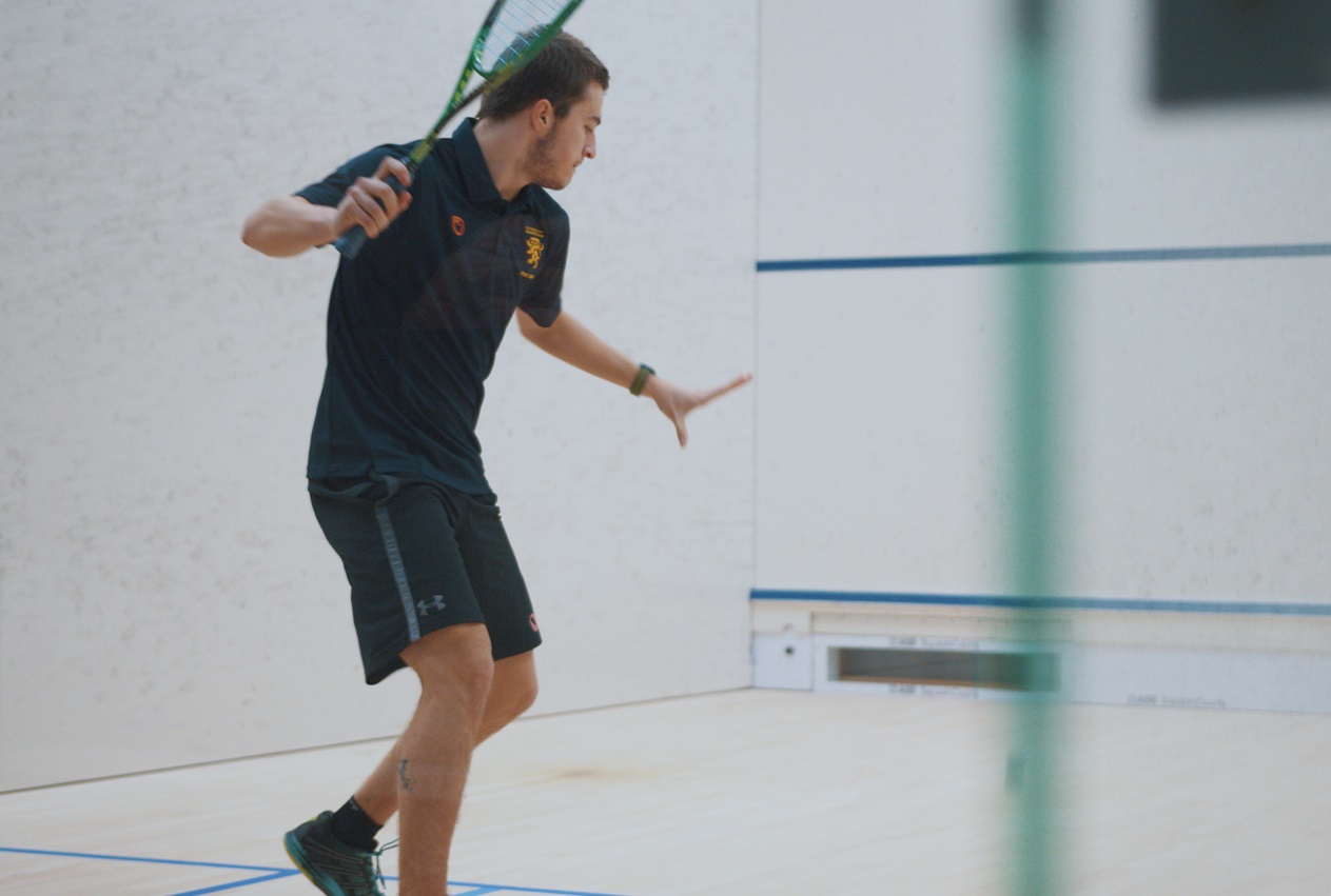 man playing squash in a court