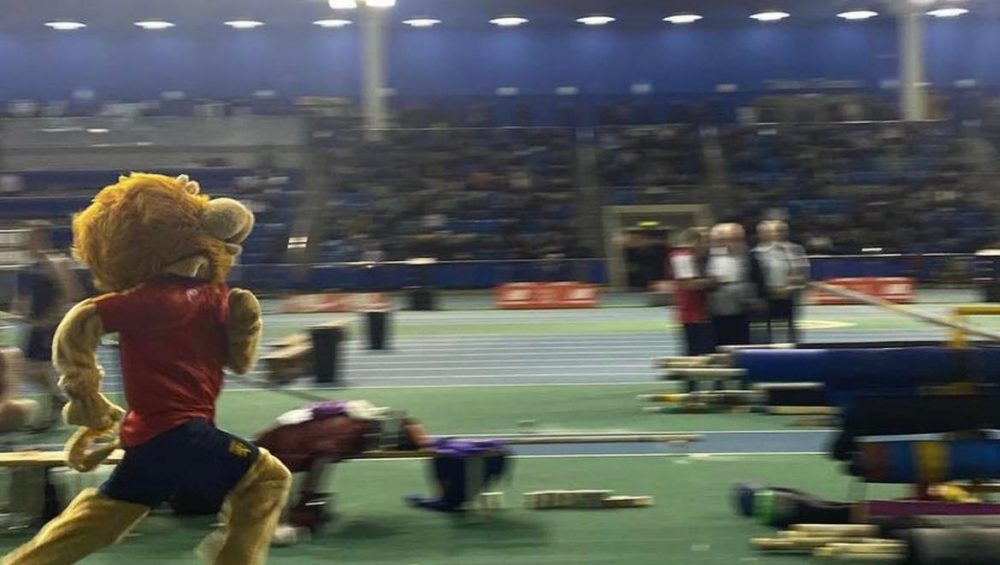 Rory the Lion mascot running on the indoor track at BUCS Nationals