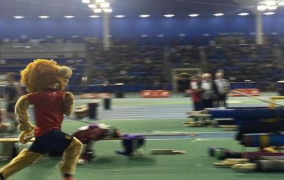 Rory the Lion mascot running on the indoor track at BUCS Nationals