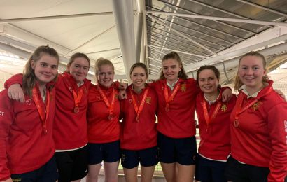 Seven of the women's cricket team stoof with their bronze medals at the National Indoor Finals