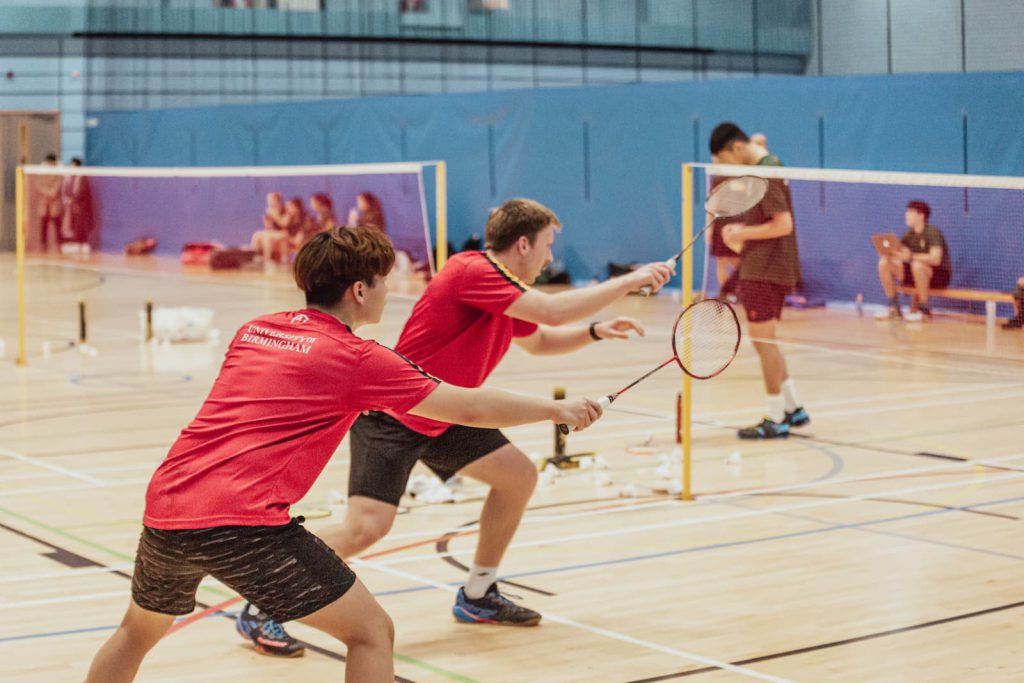Badminton Players serving during a game