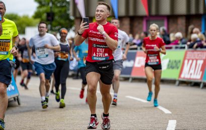 Male runner recording his run on his phone at the Great Birmingham Run 10k