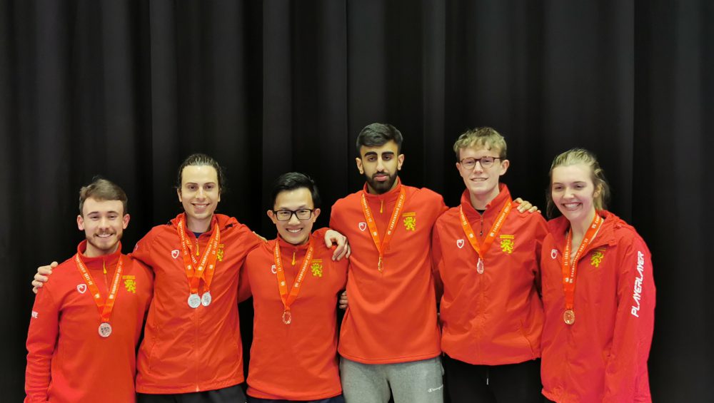 Six University of Birmingham athletes wearing their medals at the BUCS Karate Championship