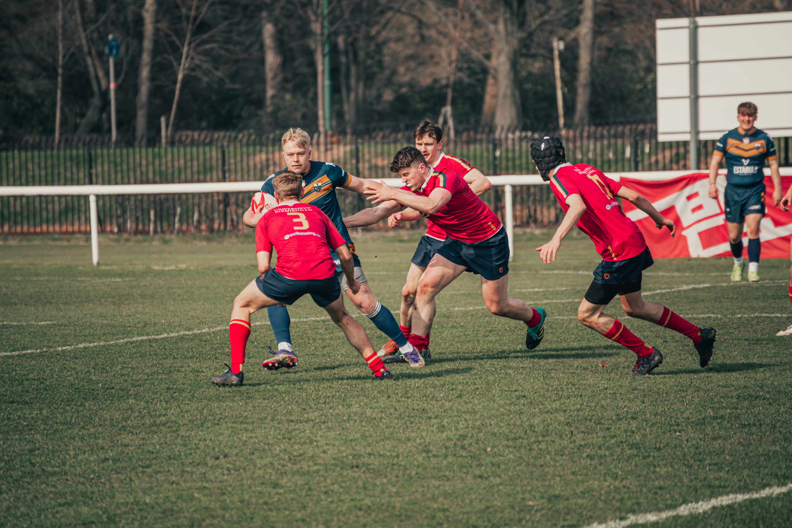 University of Birmingham rugby league players tackling a player with the ball