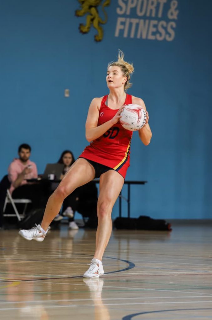 Fran Williams catching a netball on court