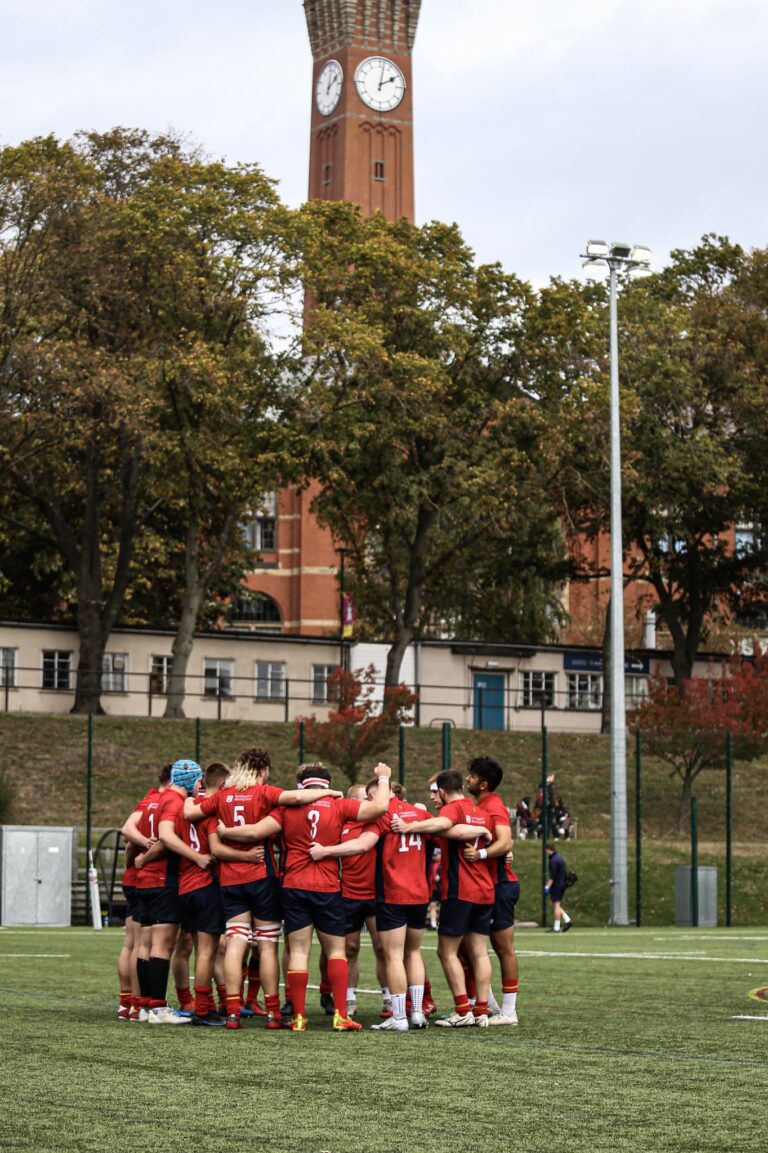 Rugby Union M1s in a group huddle