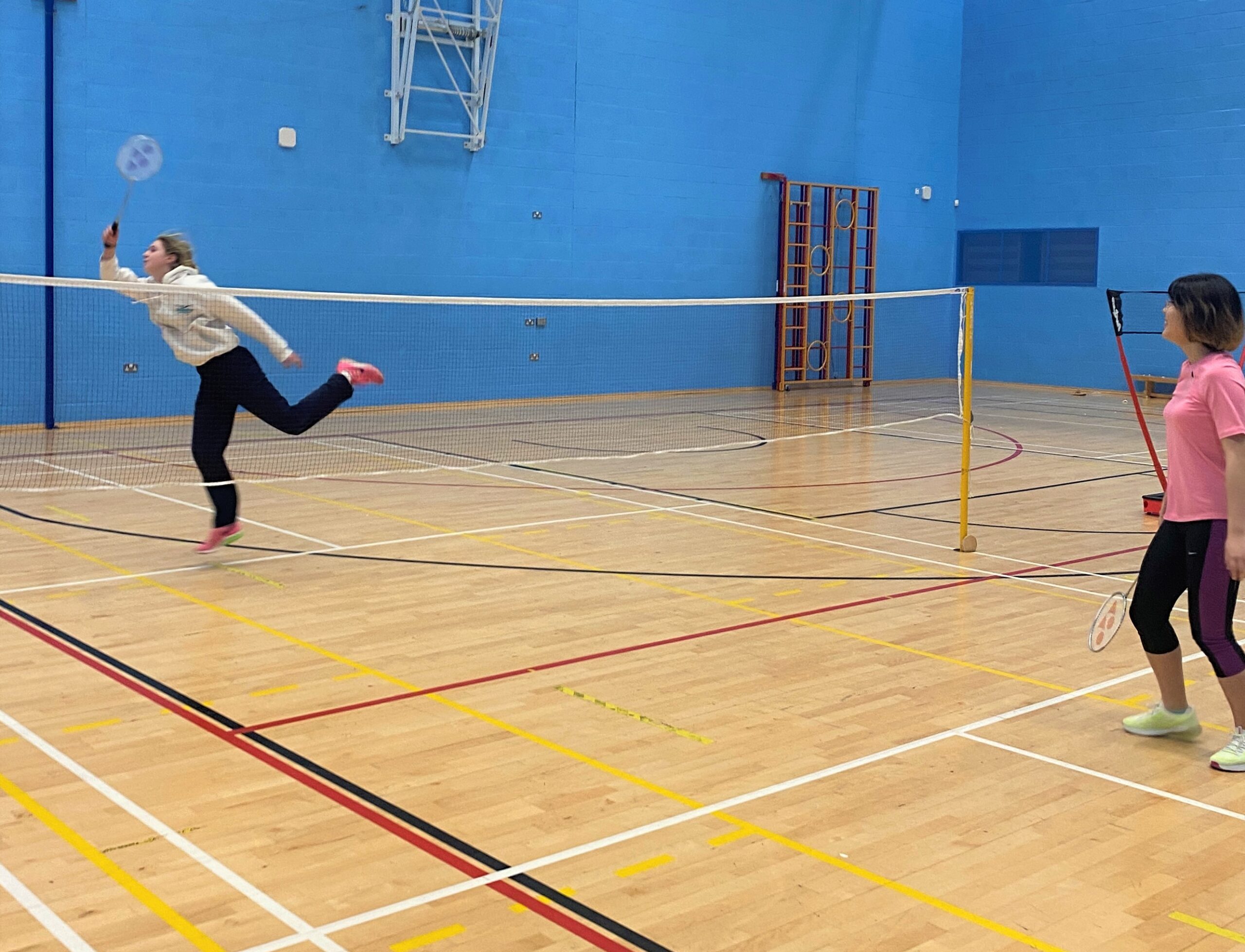 Badminton 2 Active Residences members playing badminton in the Munrow Arena