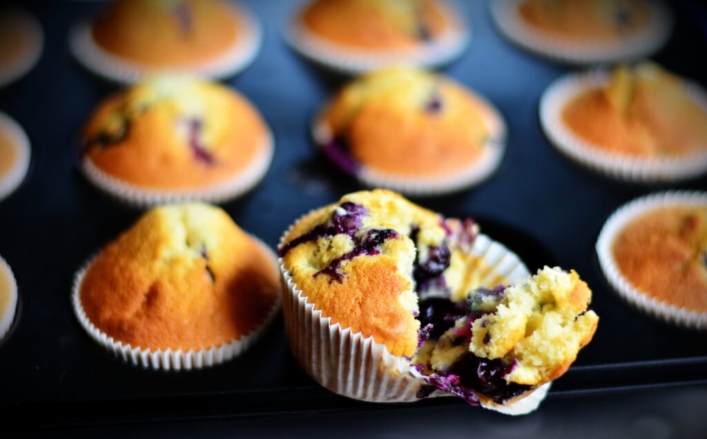 Blueberry muffin pulled apart to show the soft inner sponge