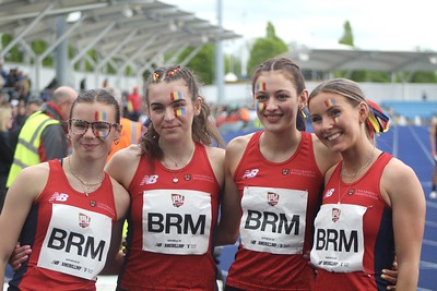 4 Female athletes smiling with yellow, blue and red facepaint at BUCS Outdoors 2023