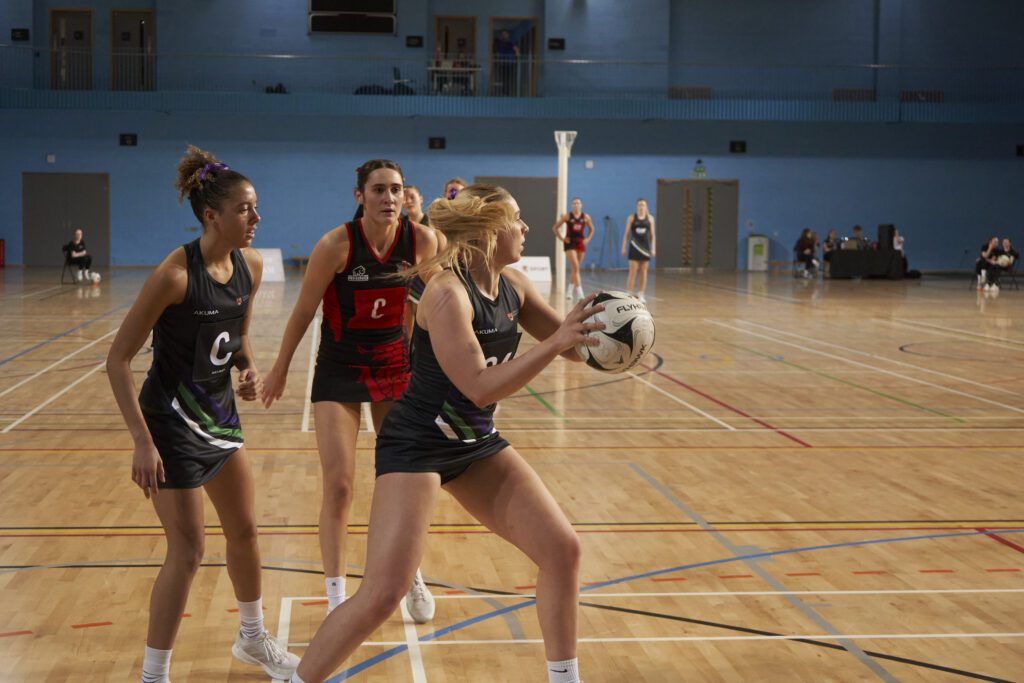 UoB female netballer running with ball at Intercept