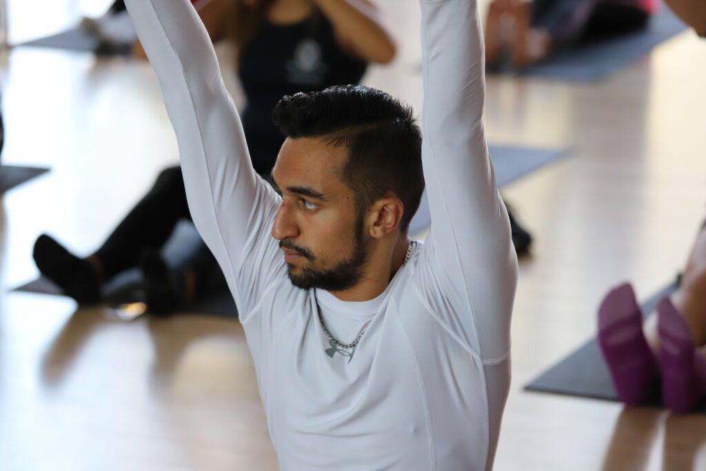 Image of a guy stretching arms upwards