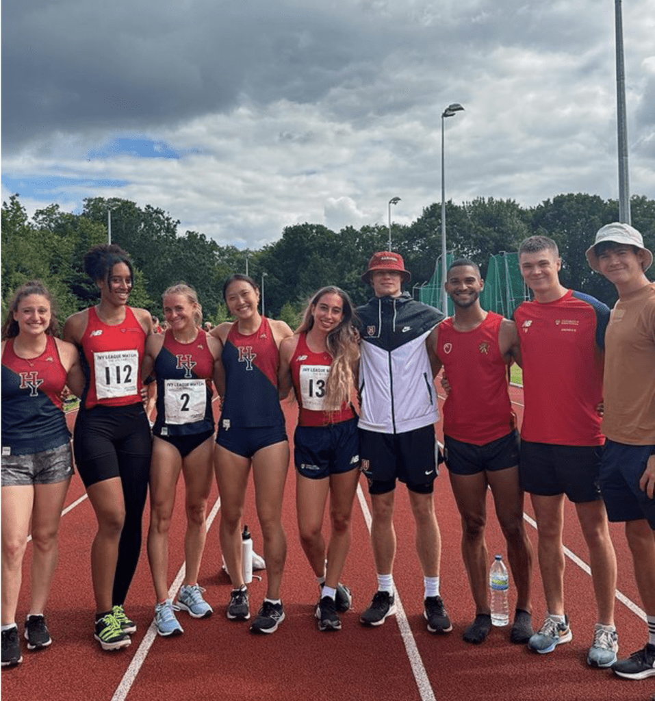 Picture of UOB Athletics team in group photo smiling on Athletics track after match