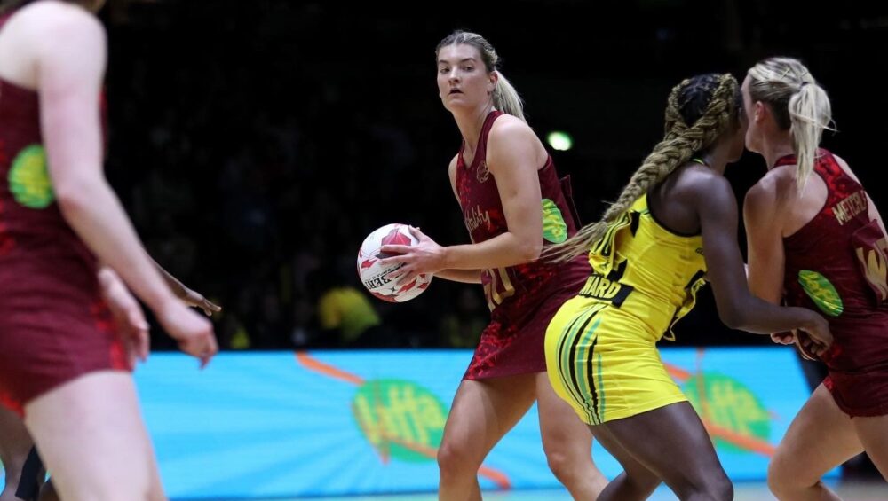 Fran playing Netball in Vitaly Roses Kit