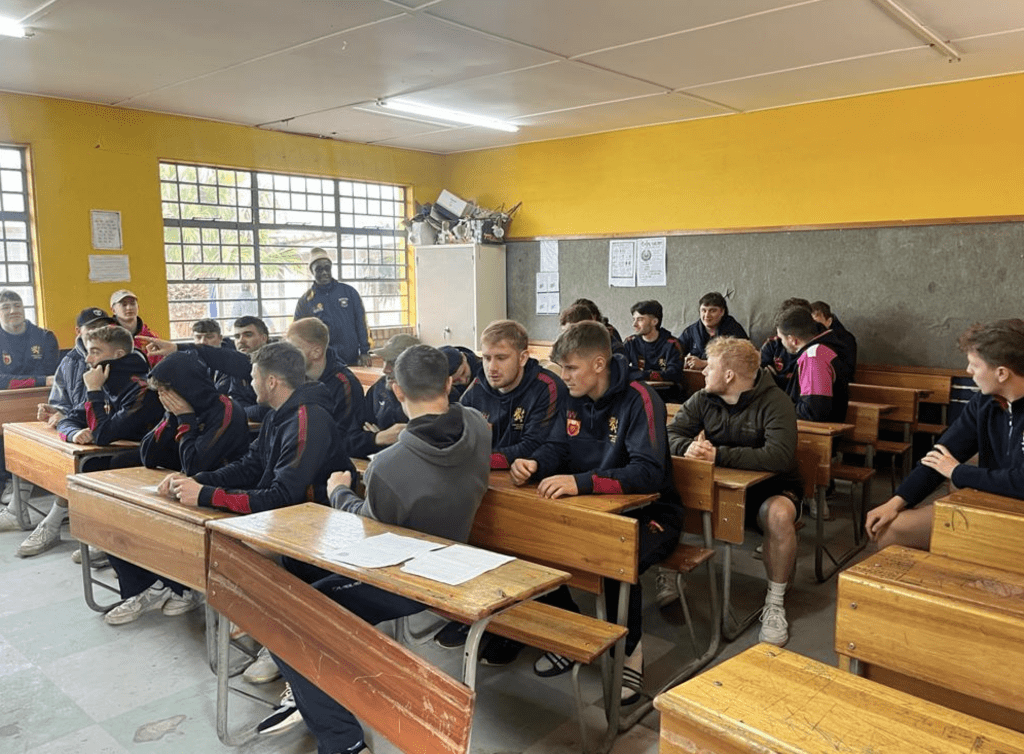Rugby Union in classroom sat down in rows of tables