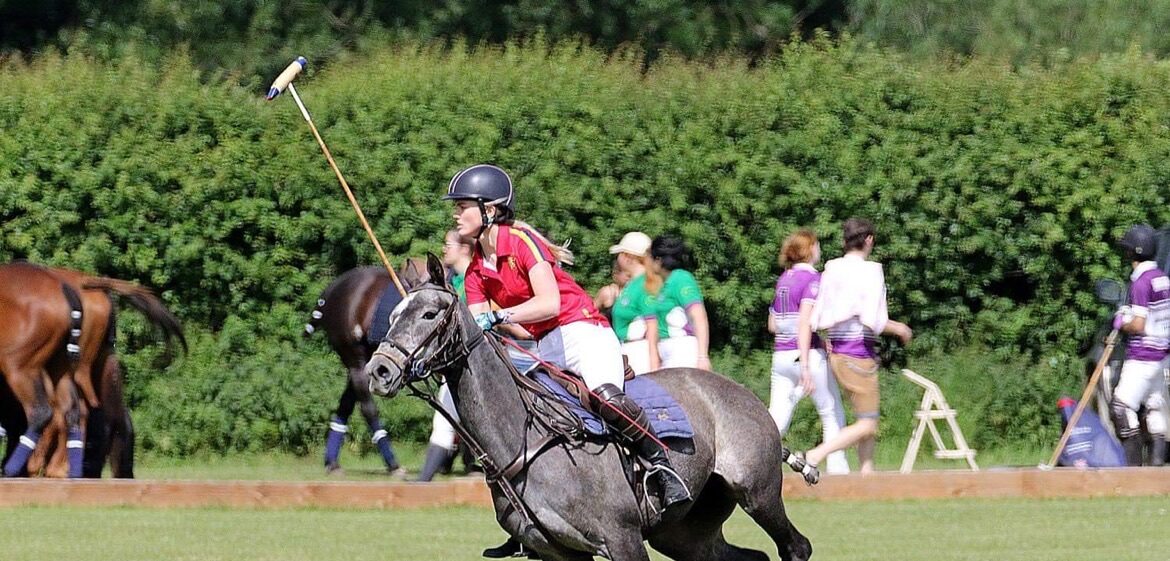 Student on horse playing polo.