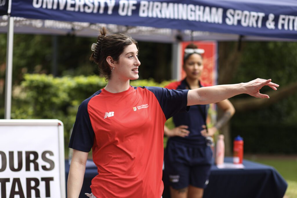 Brand Ambassador speaking and pointing at pitches whilst beginning a tour for Open day