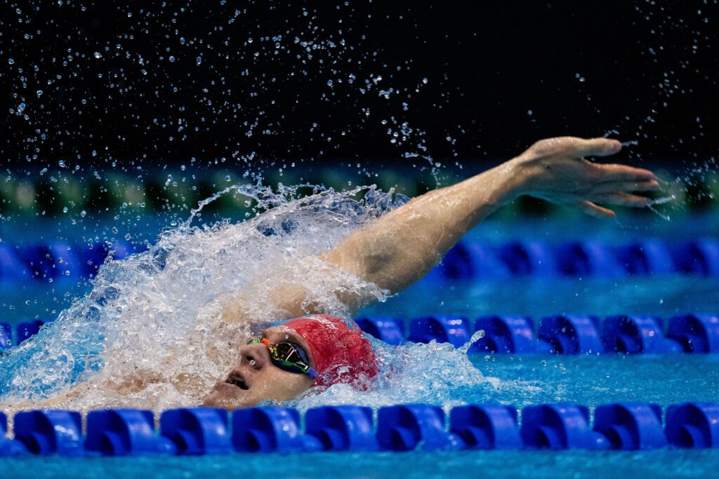 Ollie Morgan pictured swimming mid backstroke, coming up for air