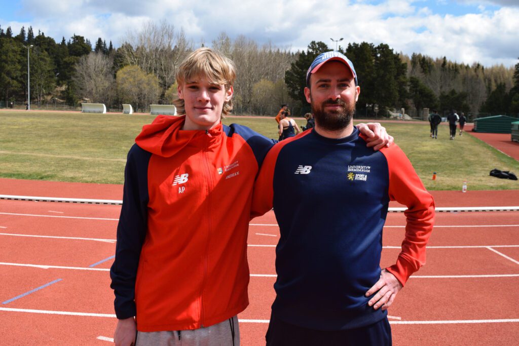 Dean pictured next to student athlete with track in background