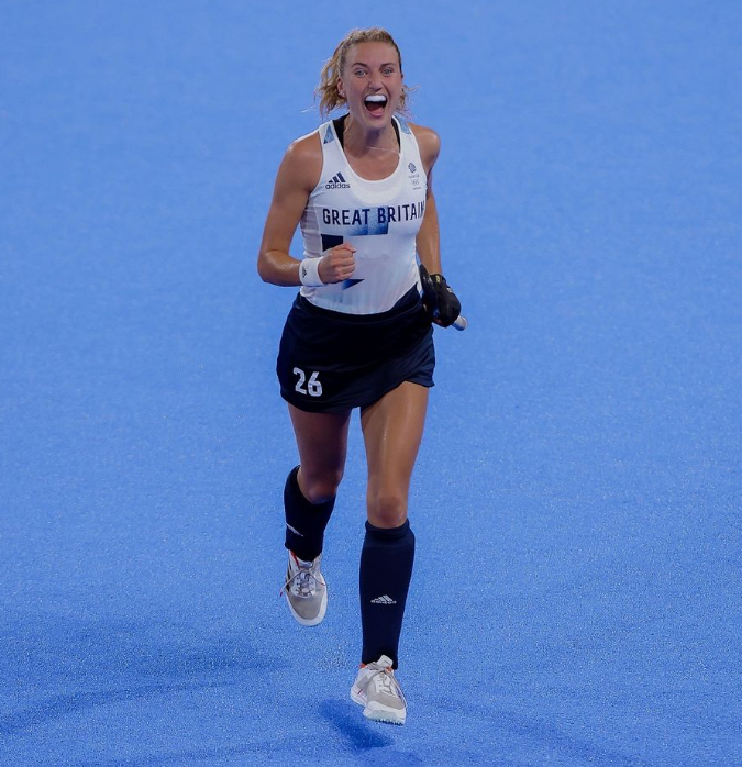 Lily Owsley cheering with her fist clenched.