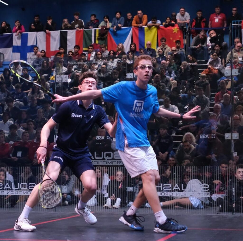 Two males competing in the glass court