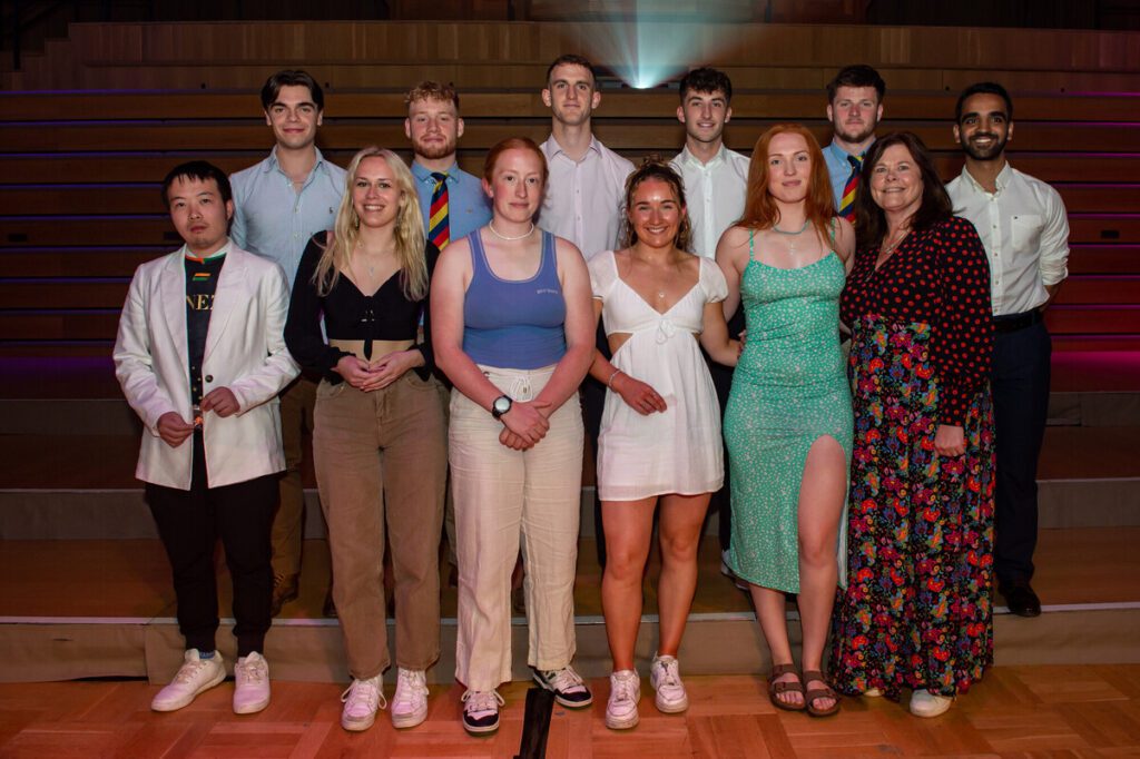 Group of students joined by Carolyn Cutbill at the Sports Awards.