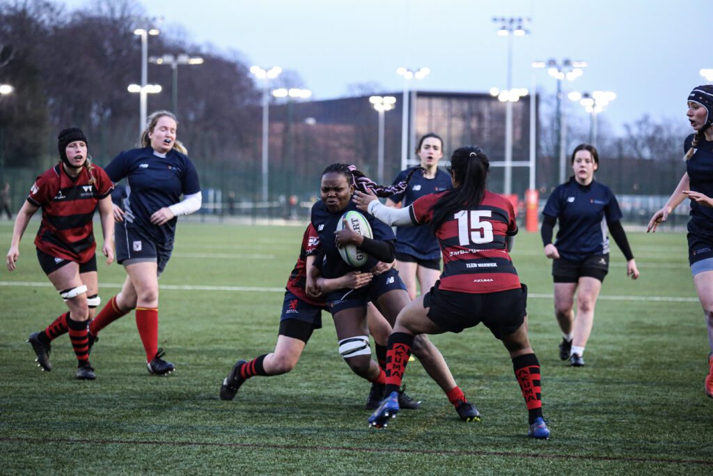 Rugby Union Women's tackling each other.