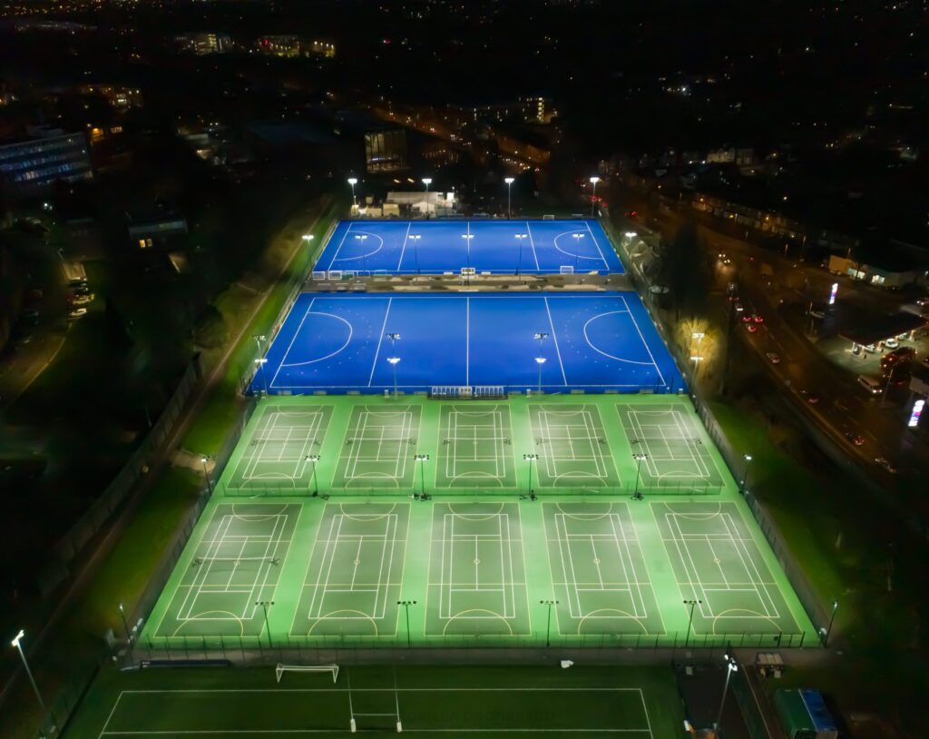 Wide shot of outdoor pitches at night (water based, tennis/netball and Bournbrook 3G)