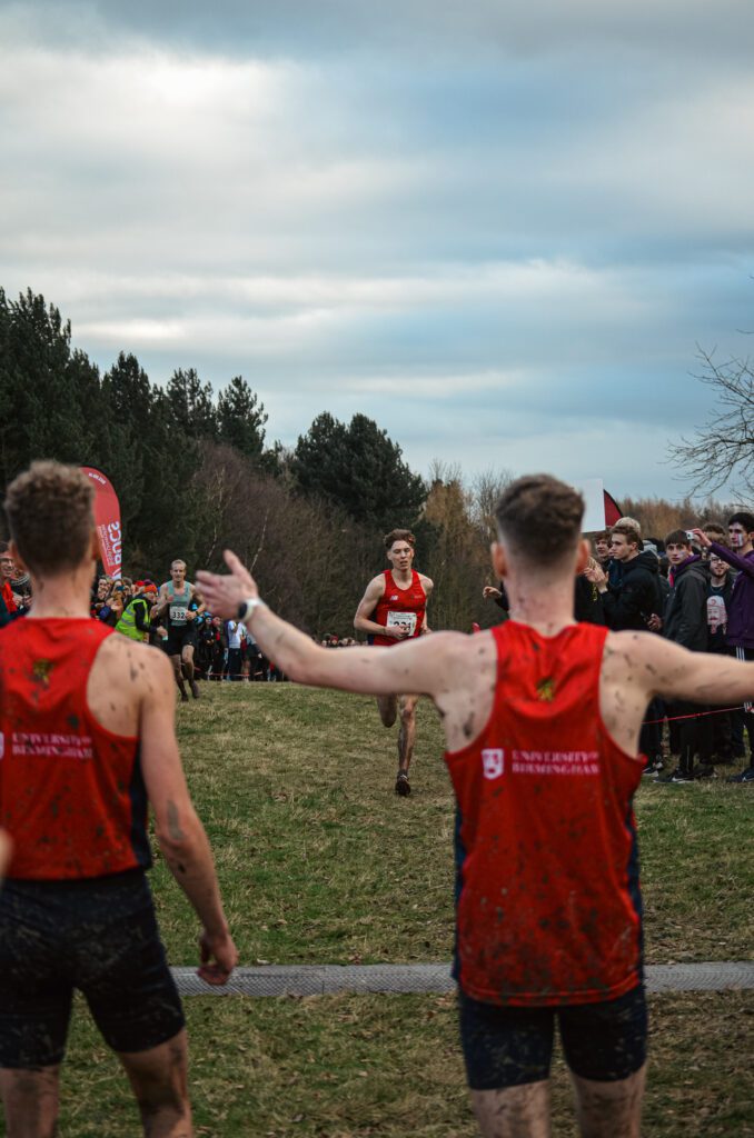 Three athletics members running in the European Cross Country Championships, heading for the finish line.