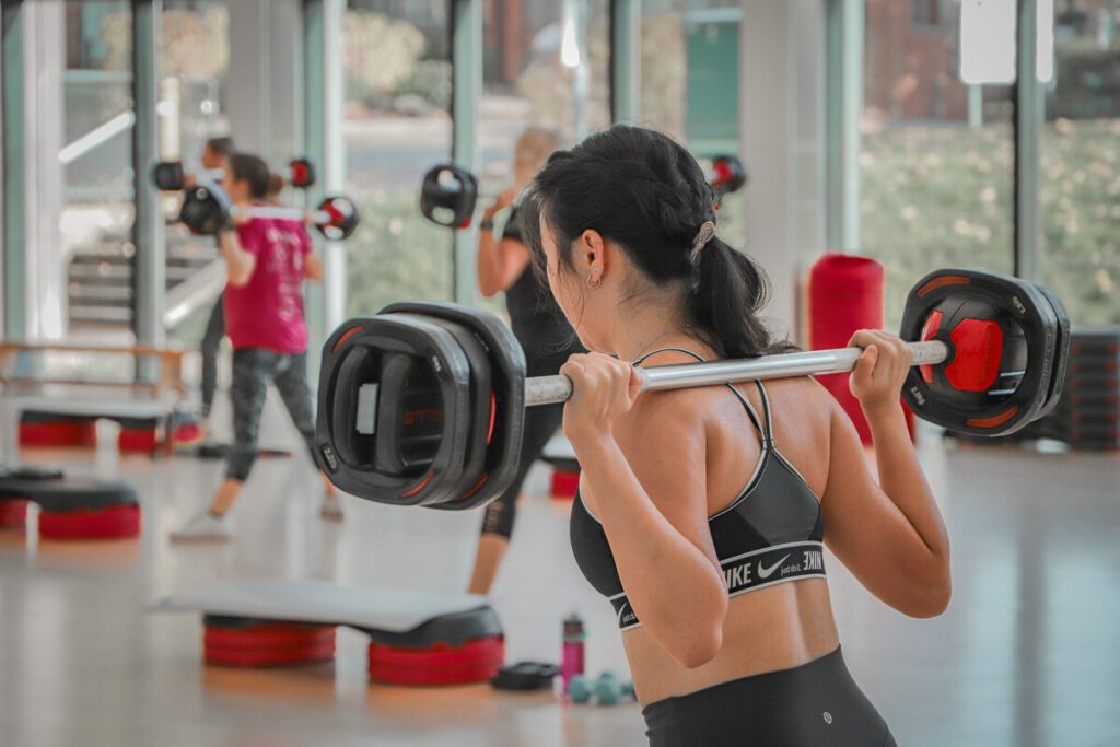 Individual working out in a Body Pump class.