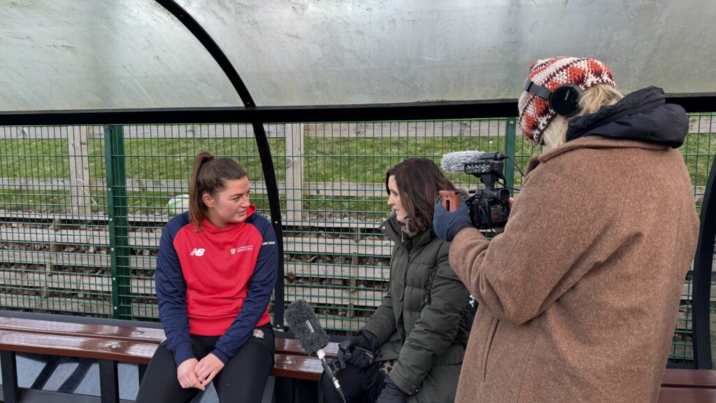 Member of women's rugby team sat on bench for interview with Katie Gornall.