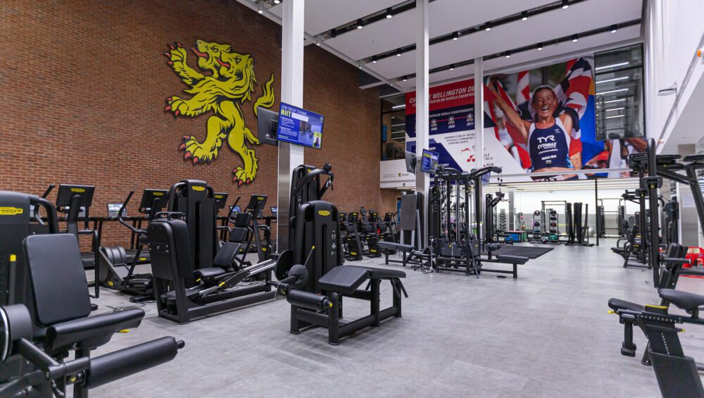 Gym area at Sport & Fitness with cardiovascular machines and weight machines.