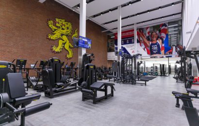 Gym area at Sport & Fitness with cardiovascular machines and weight machines.