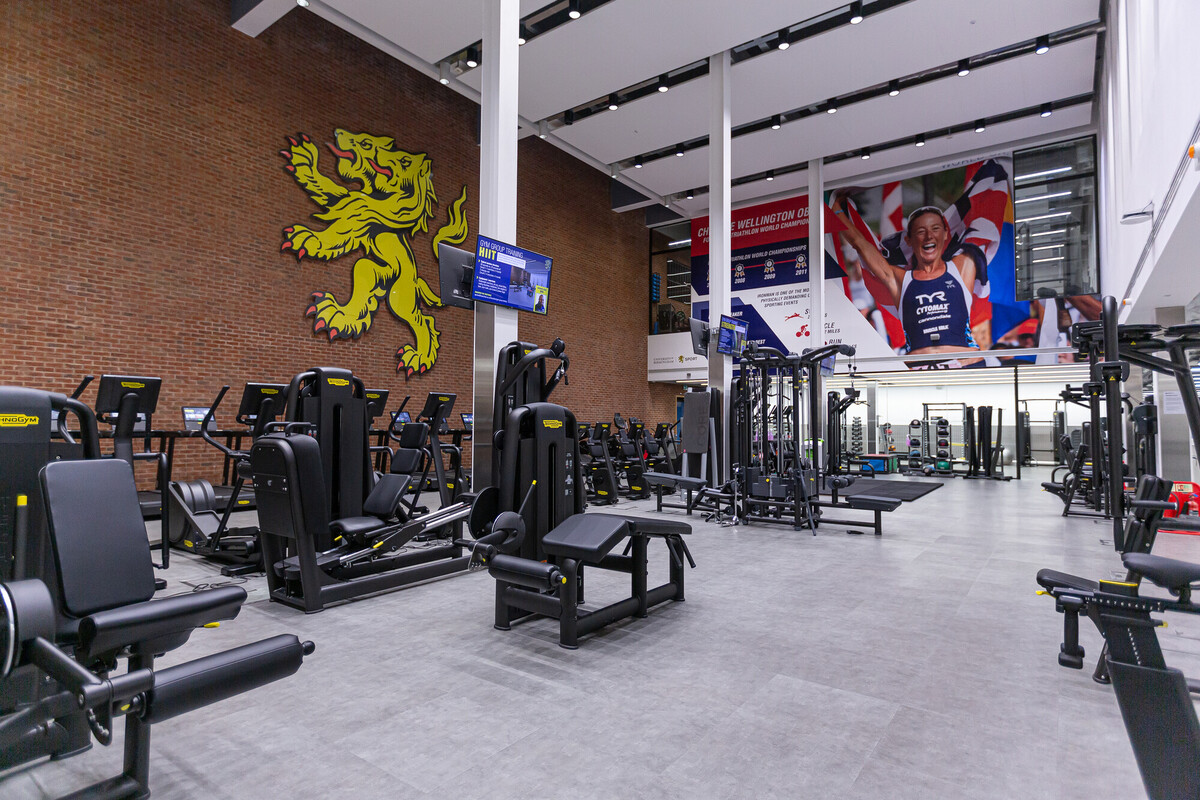 Upstairs gym area at Sport & Fitness - with lots of equipment including running machines. Along with the UoB Lion on the wall.