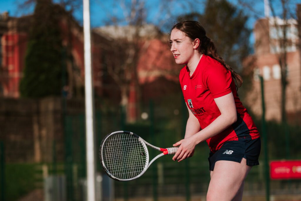 Girl playing tennis on courts in NB kit