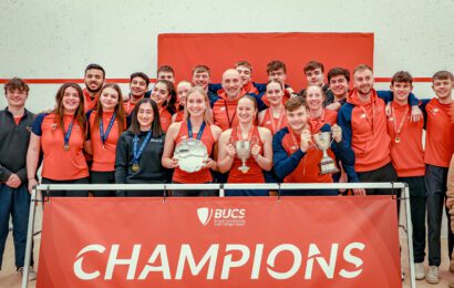 Men's and Women's Squash club winners hold trophy and stand behind Champions sign