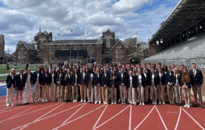 sixty students athletes from Ivy League Exchange posing on the athletics track
