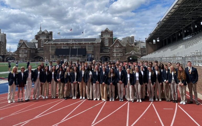 sixty students athletes from Ivy League Exchange posing on the athletics track