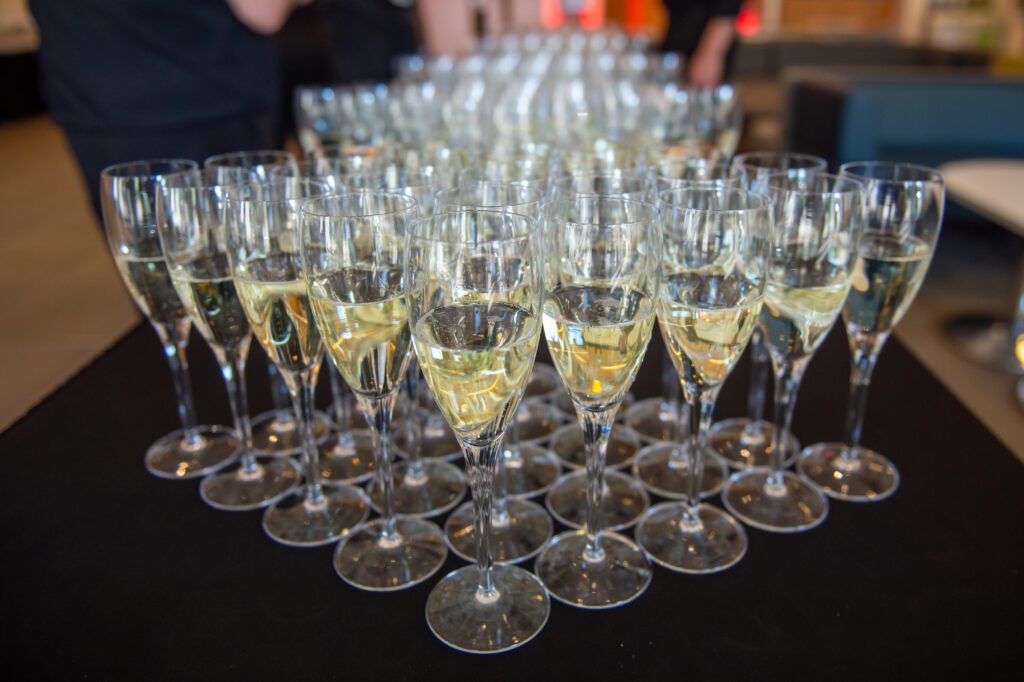 Champagne glasses in pyramid shape on serving table